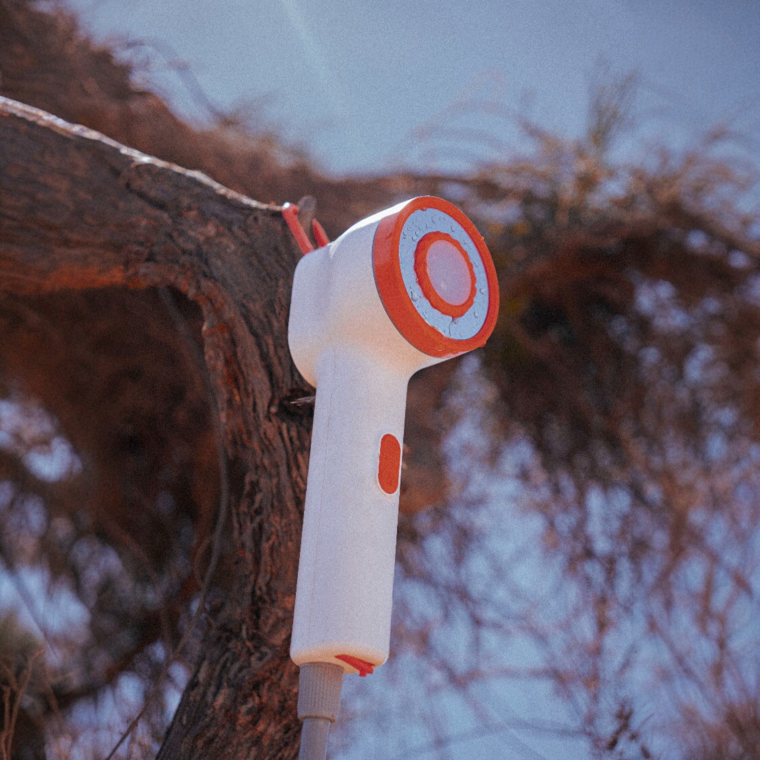 Niche Outdoors Portable Lithium Camp Shower hanging off tree