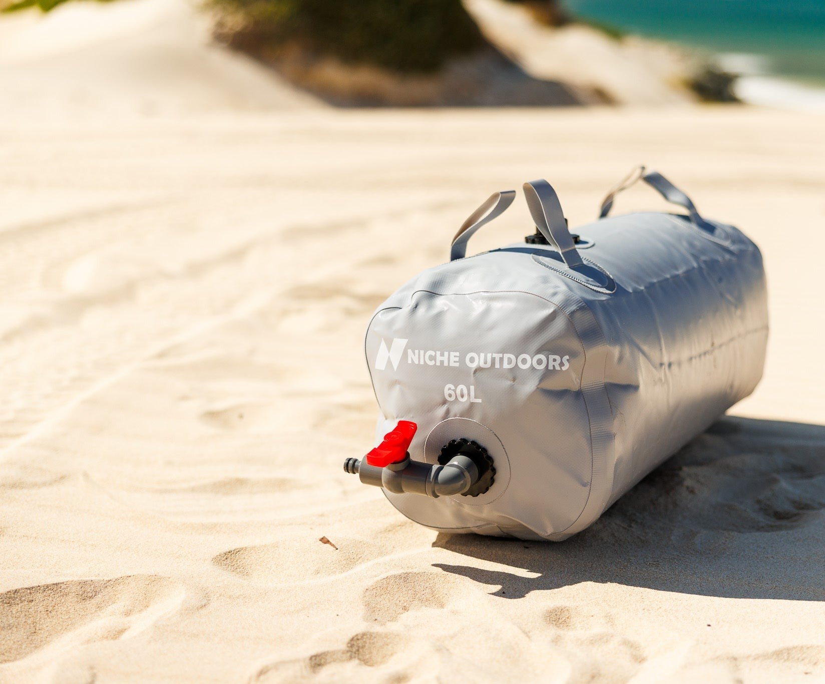 Niche Outdoors 60L Slim water bladder on a beach