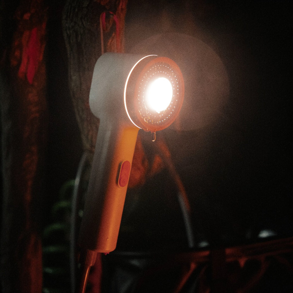 Niche Outdoors Portable Lithium Camp Shower at night with light on 