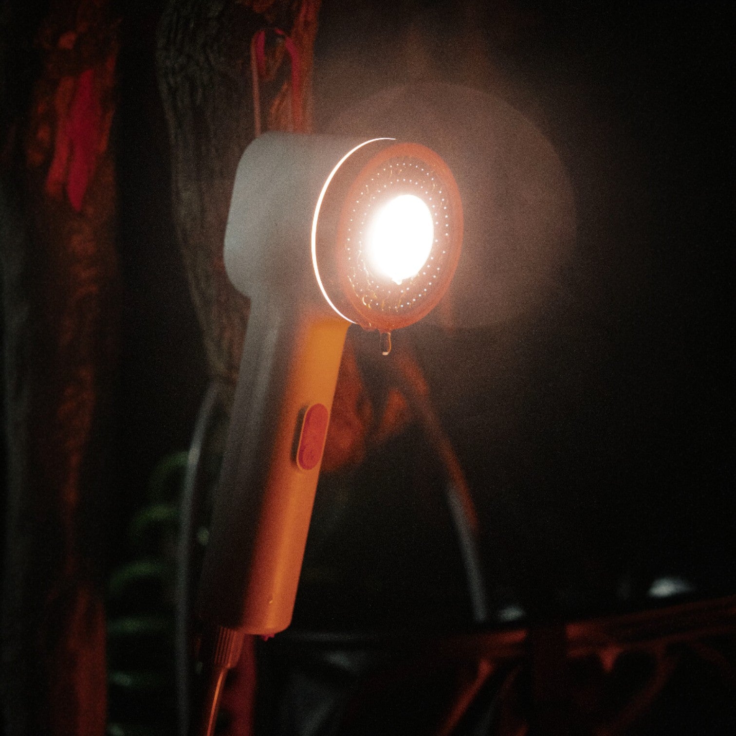 Niche Outdoors Portable Lithium Camp Shower at night with light on 